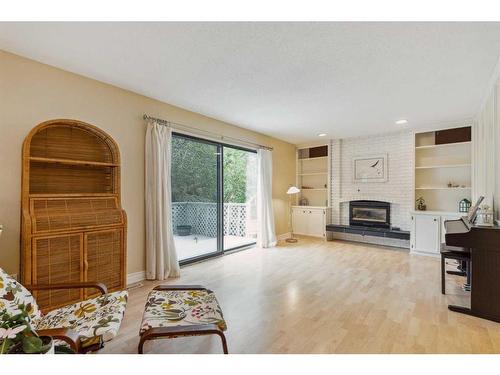 119 Oakside Place Sw, Calgary, AB - Indoor Photo Showing Living Room With Fireplace