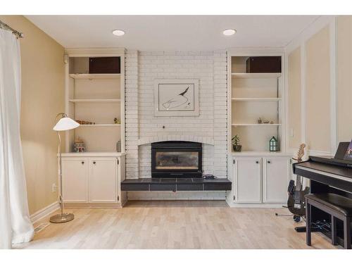 119 Oakside Place Sw, Calgary, AB - Indoor Photo Showing Other Room With Fireplace