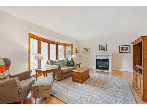 119 Oakside Place Sw, Calgary, AB - Indoor Photo Showing Living Room With Fireplace