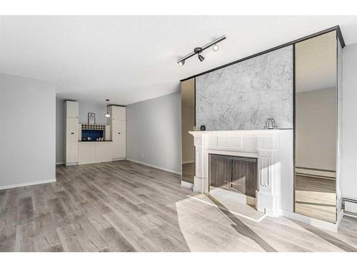 207-3730 50 Street Nw, Calgary, AB - Indoor Photo Showing Living Room With Fireplace