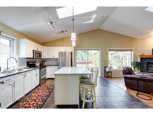 186 West Lakeview Passage, Chestermere, AB - Indoor Photo Showing Kitchen With Fireplace