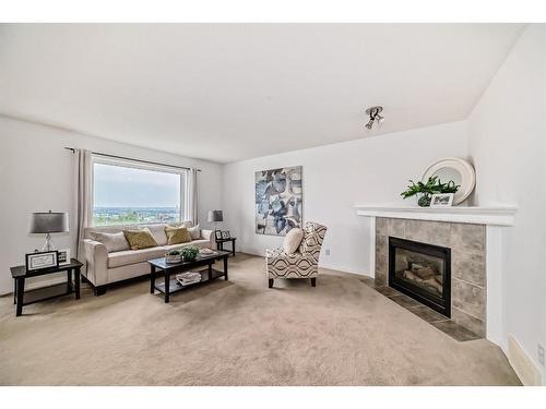 234 Panamount Hill Nw, Calgary, AB - Indoor Photo Showing Living Room With Fireplace