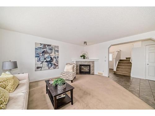 234 Panamount Hill Nw, Calgary, AB - Indoor Photo Showing Living Room With Fireplace