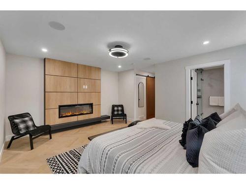 3723 Logan Crescent Sw, Calgary, AB - Indoor Photo Showing Bedroom With Fireplace