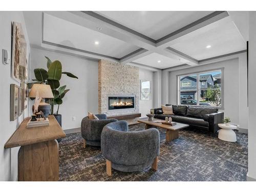 418-125 Wolf Hollow Crescent Se, Calgary, AB - Indoor Photo Showing Living Room With Fireplace