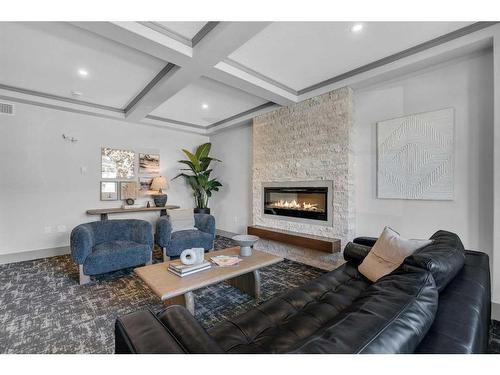 418-125 Wolf Hollow Crescent Se, Calgary, AB - Indoor Photo Showing Living Room With Fireplace