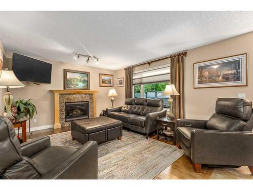 1733 Evergreen Drive Sw, Calgary, AB - Indoor Photo Showing Living Room With Fireplace