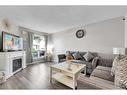 11 Falchurch Road Ne, Calgary, AB  - Indoor Photo Showing Living Room With Fireplace 