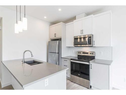 29 Spring Creek Common Sw, Calgary, AB - Indoor Photo Showing Kitchen With Stainless Steel Kitchen With Double Sink With Upgraded Kitchen