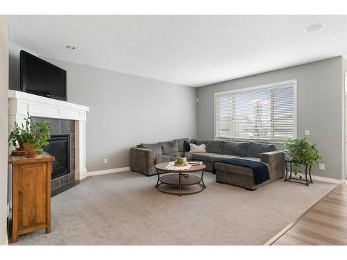 47 Sunset Terrace, Cochrane, AB - Indoor Photo Showing Living Room With Fireplace