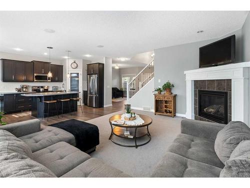 47 Sunset Terrace, Cochrane, AB - Indoor Photo Showing Living Room With Fireplace