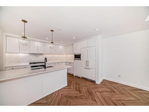 112-8445 Broadcast Avenue Sw, Calgary, AB - Indoor Photo Showing Kitchen With Double Sink