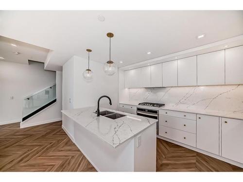 112-8445 Broadcast Avenue Sw, Calgary, AB - Indoor Photo Showing Kitchen With Double Sink With Upgraded Kitchen