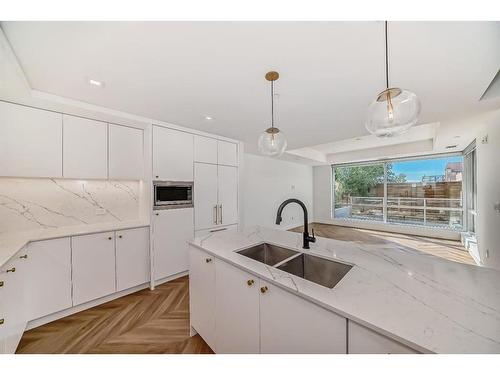 112-8445 Broadcast Avenue Sw, Calgary, AB - Indoor Photo Showing Kitchen With Double Sink