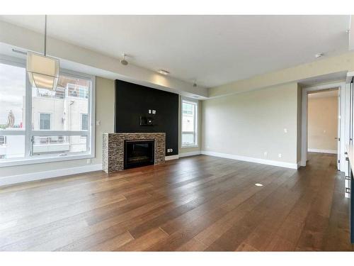 302-33 Burma Star Road Sw, Calgary, AB - Indoor Photo Showing Living Room With Fireplace