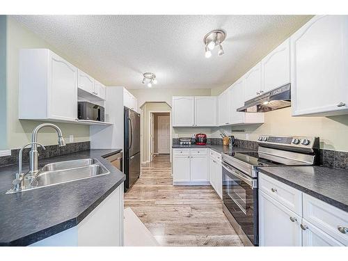 216 Cougar Ridge Drive Sw, Calgary, AB - Indoor Photo Showing Kitchen With Double Sink