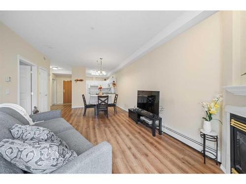 274-223 Tuscany Springs Boulevard Nw, Calgary, AB - Indoor Photo Showing Living Room With Fireplace