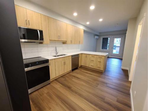 107-125 Wolf Hollow Crescent Se, Calgary, AB - Indoor Photo Showing Kitchen With Double Sink