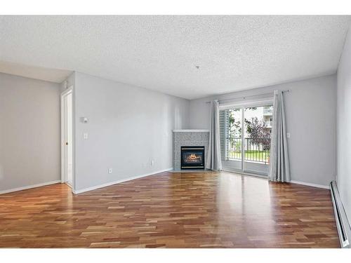 1204-6224 17 Avenue Se, Calgary, AB - Indoor Photo Showing Living Room With Fireplace