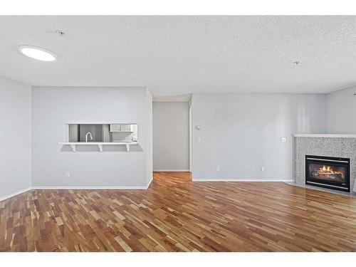 1204-6224 17 Avenue Se, Calgary, AB - Indoor Photo Showing Living Room With Fireplace