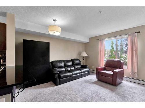 110-7210 80 Avenue Ne, Calgary, AB - Indoor Photo Showing Living Room