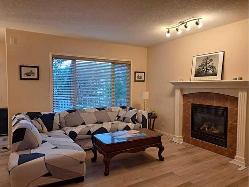 383 Everglade Circle Sw, Calgary, AB - Indoor Photo Showing Living Room With Fireplace