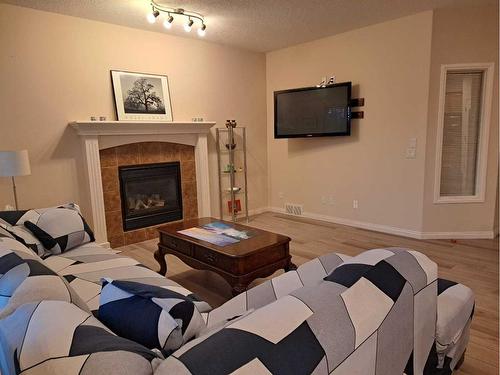 383 Everglade Circle Sw, Calgary, AB - Indoor Photo Showing Living Room With Fireplace