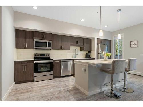 210-7 Westpark Common Sw, Calgary, AB - Indoor Photo Showing Kitchen With Stainless Steel Kitchen With Upgraded Kitchen