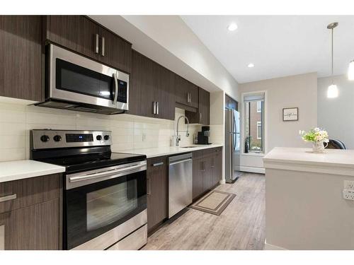 210-7 Westpark Common Sw, Calgary, AB - Indoor Photo Showing Kitchen With Stainless Steel Kitchen With Upgraded Kitchen