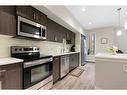 210-7 Westpark Common Sw, Calgary, AB  - Indoor Photo Showing Kitchen With Stainless Steel Kitchen With Upgraded Kitchen 