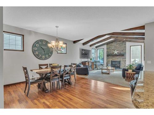 22 Cranarch Link Se, Calgary, AB - Indoor Photo Showing Dining Room With Fireplace