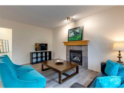 49 Everglen Crescent Sw, Calgary, AB - Indoor Photo Showing Living Room With Fireplace