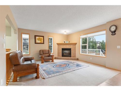 472 Bridlemeadows Common Sw, Calgary, AB - Indoor Photo Showing Living Room With Fireplace