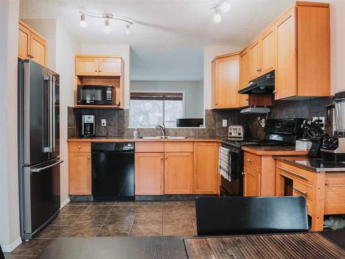 207 Cranberry Way Se, Calgary, AB - Indoor Photo Showing Kitchen With Double Sink