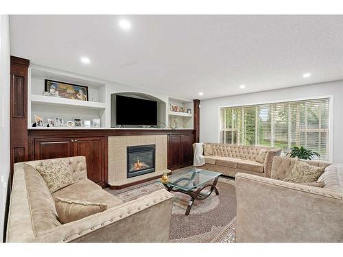 276 Cove Dr, Chestermere, AB - Indoor Photo Showing Living Room With Fireplace