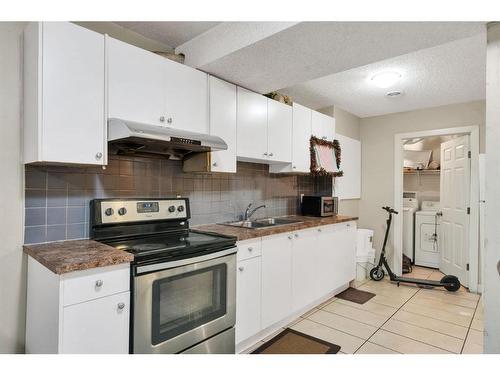 250 Saddlecrest Close Ne, Calgary, AB - Indoor Photo Showing Kitchen With Double Sink