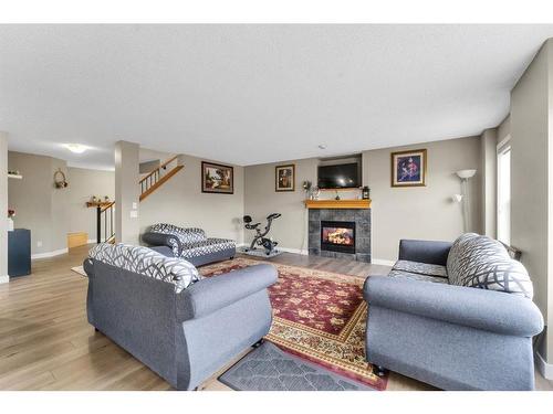 250 Saddlecrest Close Ne, Calgary, AB - Indoor Photo Showing Living Room With Fireplace