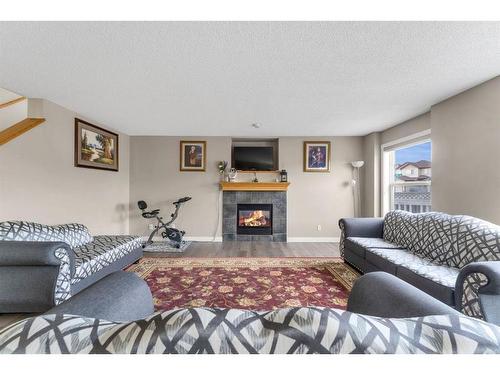 250 Saddlecrest Close Ne, Calgary, AB - Indoor Photo Showing Living Room With Fireplace