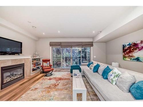 2-1934 24A Street Sw, Calgary, AB - Indoor Photo Showing Living Room With Fireplace