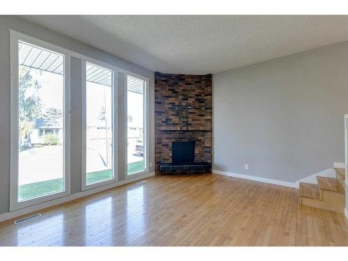 83 Lake Sylvan Close Se, Calgary, AB - Indoor Photo Showing Living Room With Fireplace