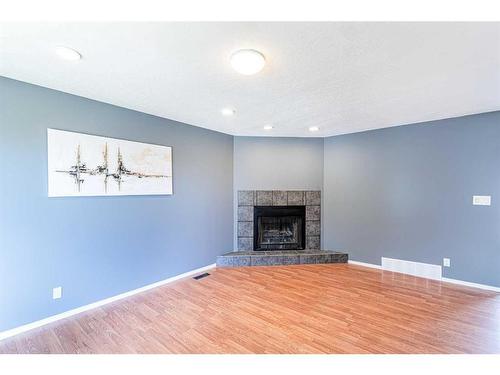 4152 Doverbrook Road Se, Calgary, AB - Indoor Photo Showing Living Room With Fireplace