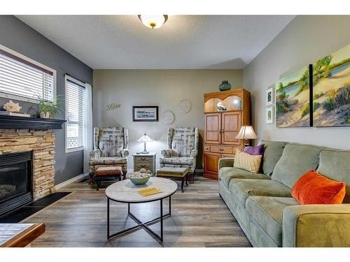 112 Inverness Drive Se, Calgary, AB - Indoor Photo Showing Living Room With Fireplace