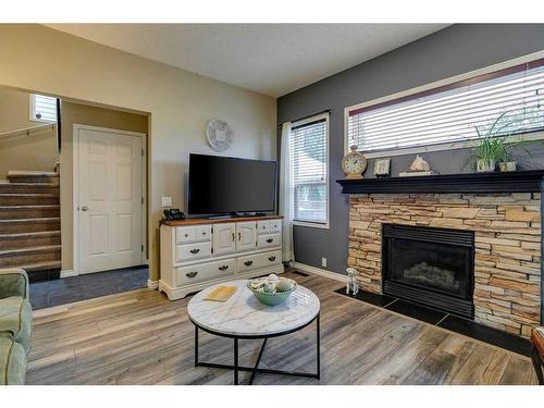 112 Inverness Drive Se, Calgary, AB - Indoor Photo Showing Living Room With Fireplace