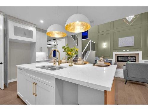 335 Waterford Grove, Chestermere, AB - Indoor Photo Showing Kitchen With Fireplace With Double Sink