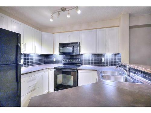 2113-16969 24 Street Sw, Calgary, AB - Indoor Photo Showing Kitchen With Double Sink