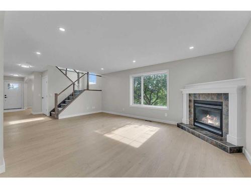 118 Springmere Drive, Chestermere, AB - Indoor Photo Showing Living Room With Fireplace