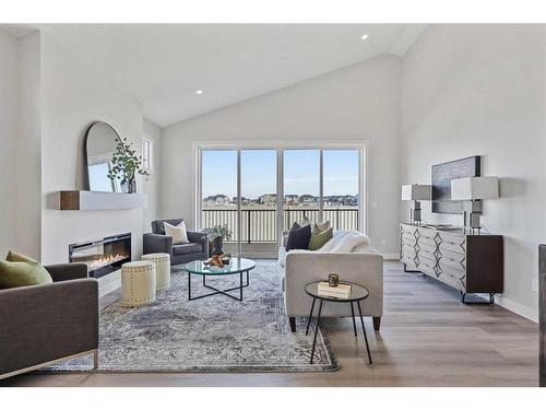 354 Baywater Common Sw, Airdrie, AB - Indoor Photo Showing Living Room With Fireplace