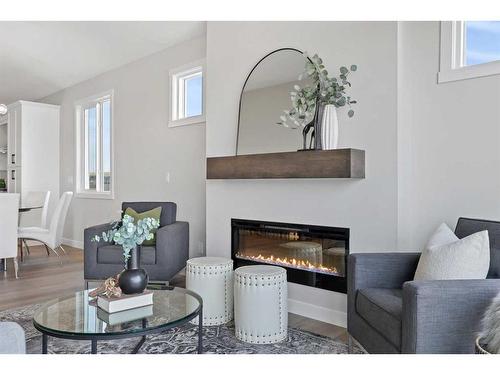 354 Baywater Common Sw, Airdrie, AB - Indoor Photo Showing Living Room With Fireplace