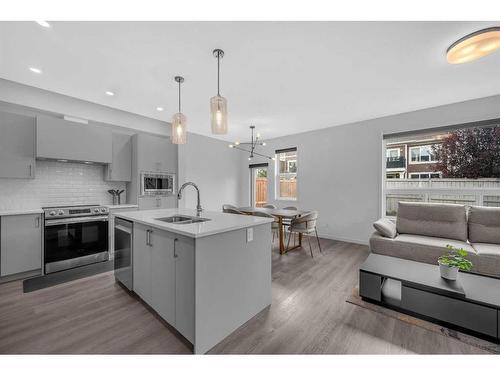 704 South Point Heath Sw, Airdrie, AB - Indoor Photo Showing Kitchen With Double Sink With Upgraded Kitchen