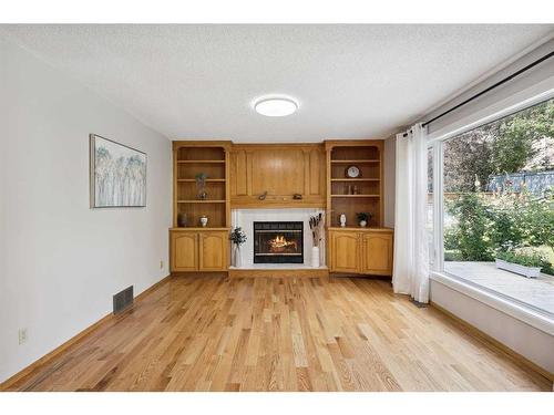 5994 Signal Ridge Heights Sw, Calgary, AB - Indoor Photo Showing Living Room With Fireplace